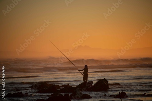 Fisherman at sunset on Maitland Beach, South Africa © dirkseyfried
