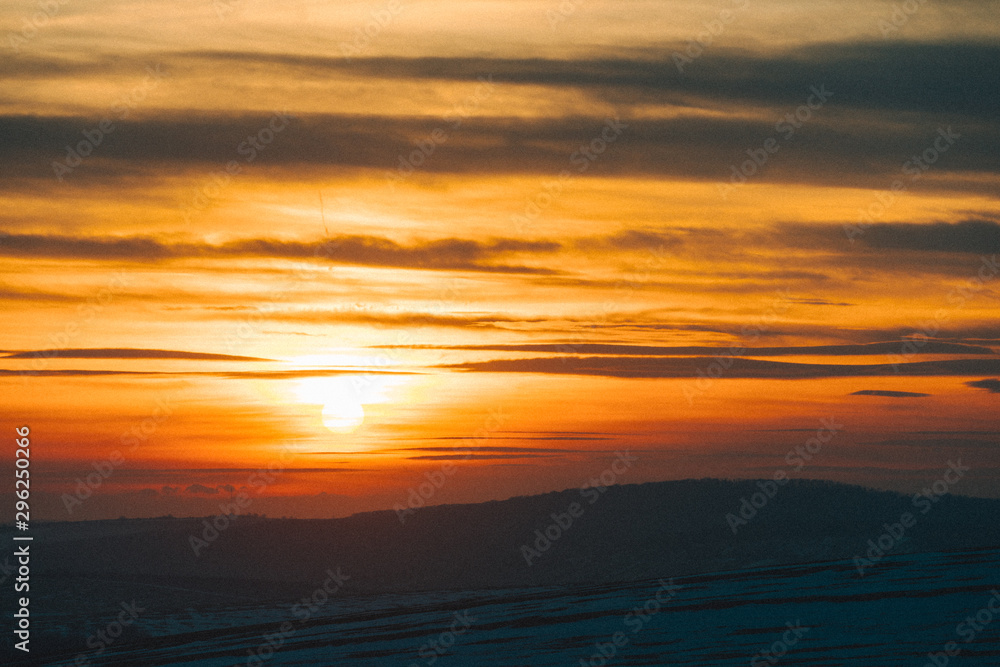 sunset over winter snowed field