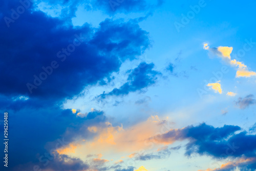 Bright cumulus clouds against the blue sky. Sunset sky Natural background