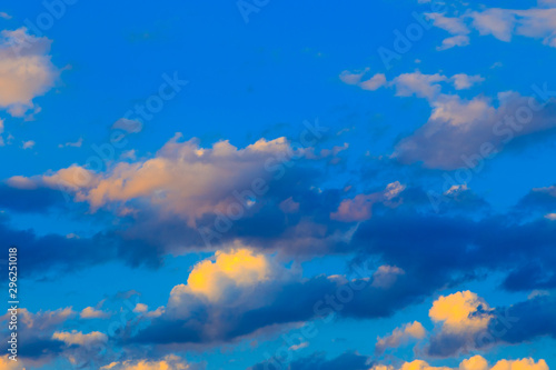 Bright cumulus clouds against the blue sky. Sunset sky Natural background