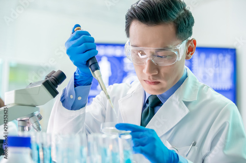 Asian scientist take petri dish