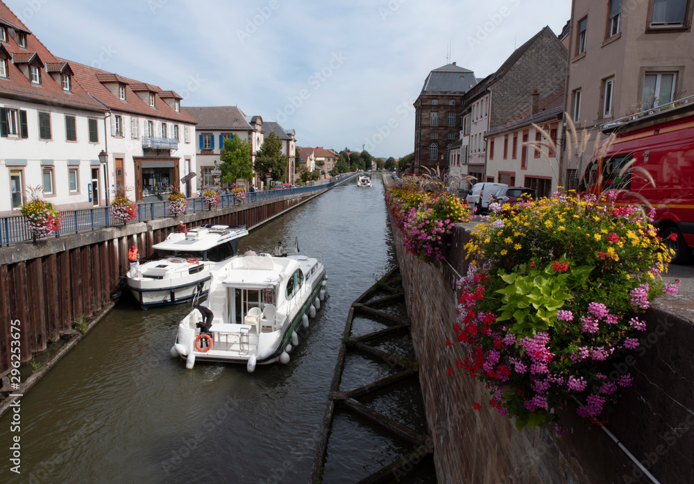 Two tourist boats cross paths on a river in Alsace, France