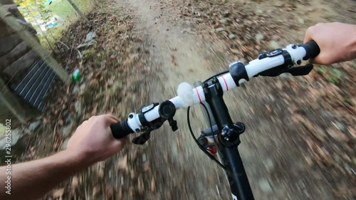 POV, Original point of view. Going down on bicycle. Moutain bikie in the forest. photo