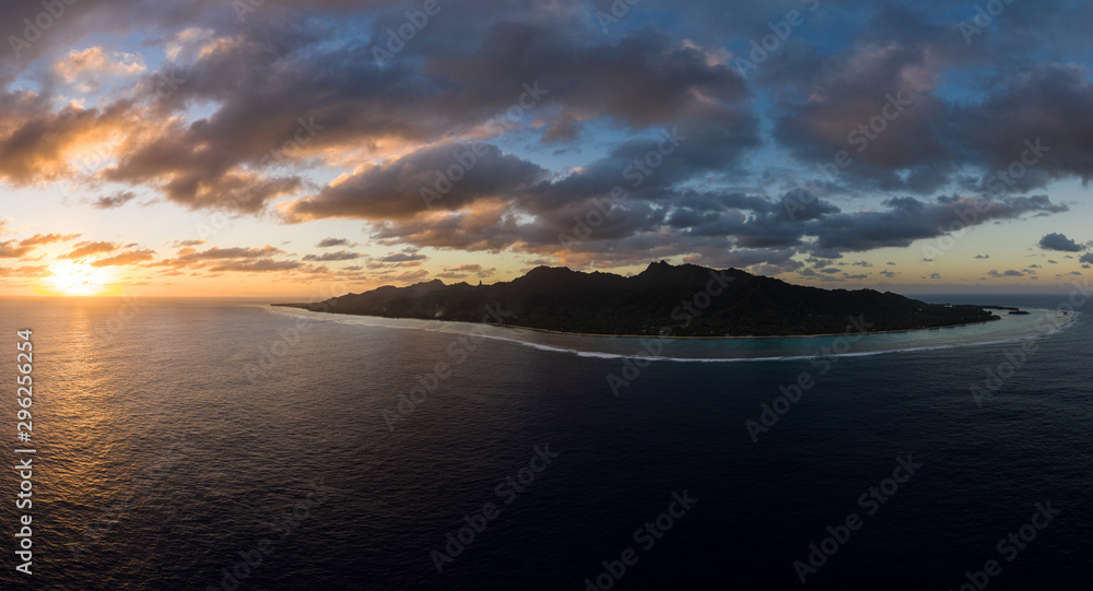 Aerial panorama of the entire Rarotonga island during a dramatic sunset in the Cooks island archipelago in the south Pacific.
