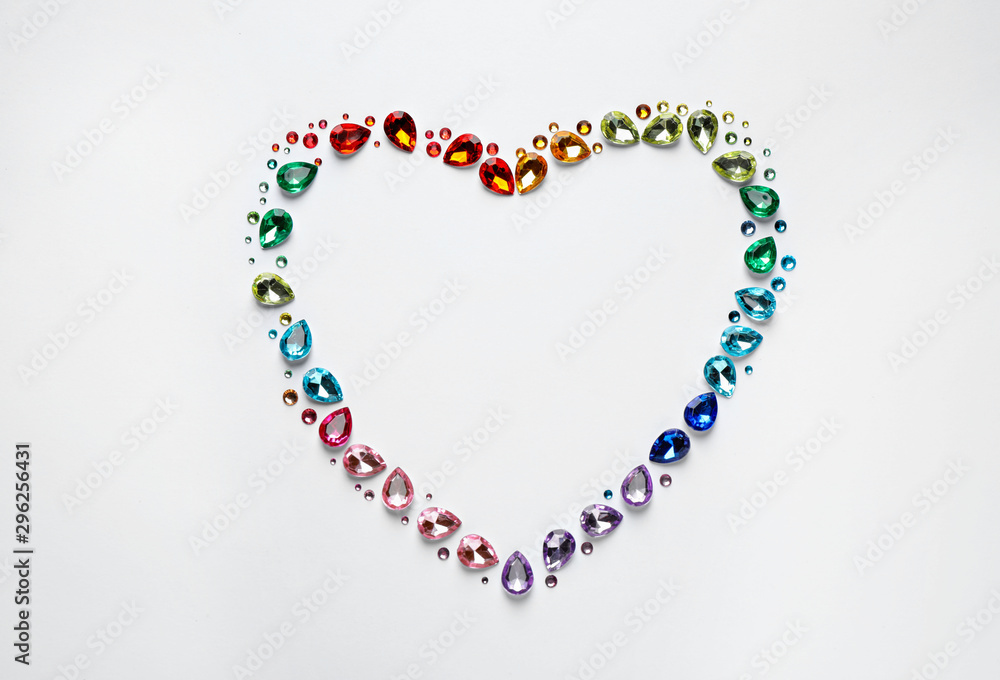 Obraz premium Frame made of different beautiful gemstones on white background, top view. Space for text
