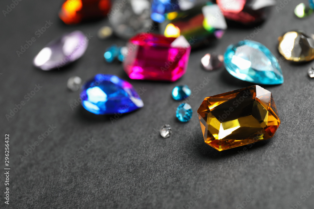 Different beautiful gemstones on black background. Space for text Different beautiful gemstones on black background. Space for text