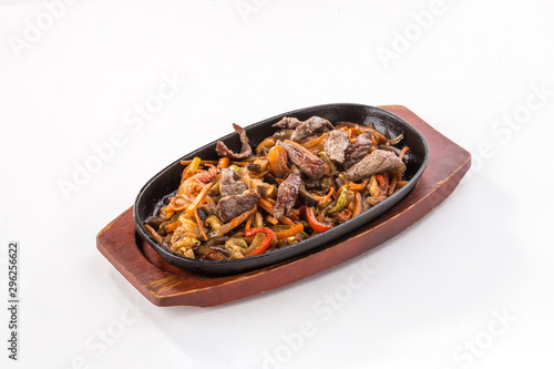 Beef fajitas with colorful vegetables in pan isolated on white background photo