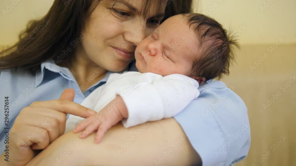 Portrait of mother face and newborn baby, mother holding and caressing child Portrait of mother face and newborn baby, mother holding and caressing child