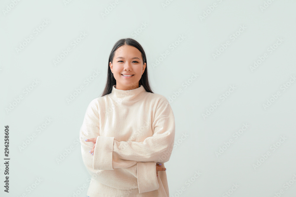 Portrait of beautiful Asian woman on light background Portrait of beautiful Asian woman on light background