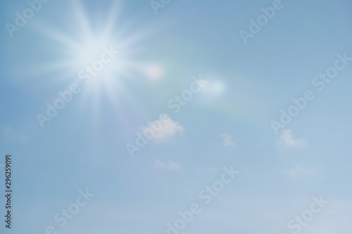 Blue sky with sun reflection. Sunny background. Sun appear directly above Thailand. The afternoon summer sun shines on a beautiful sky with clouds.