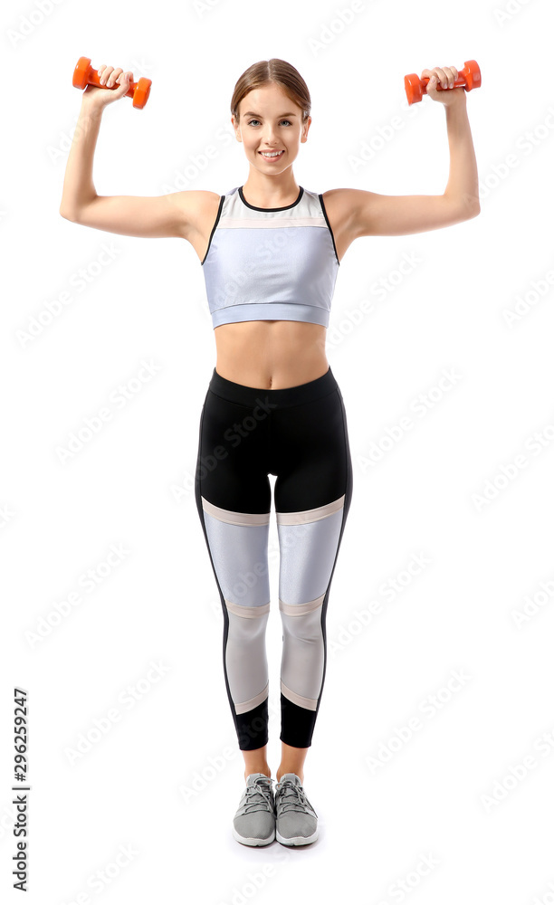 Sporty young woman training with dumbbells against white background Sporty young woman training with dumbbells against white background