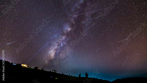 Slika na platnu Long time exposure night landscape with the milky way during meteor shower over a mountain with hut
