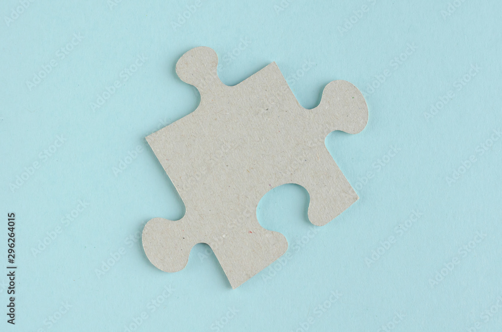 Gray puzzles composition on blue background. Flat lay Gray puzzles composition on blue background. Flat lay