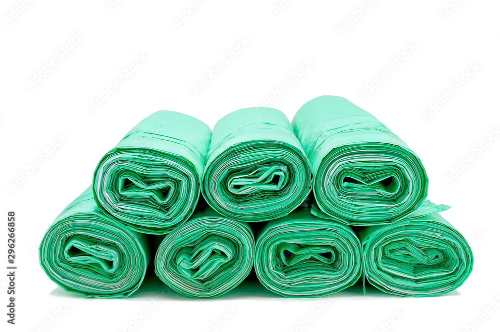 Rolled Green Drawstring Plastic Trash Bags on White Background. Waste Management Concept. Rolled Green Drawstring Plastic Trash Bags on White Background. Waste Management Concept.