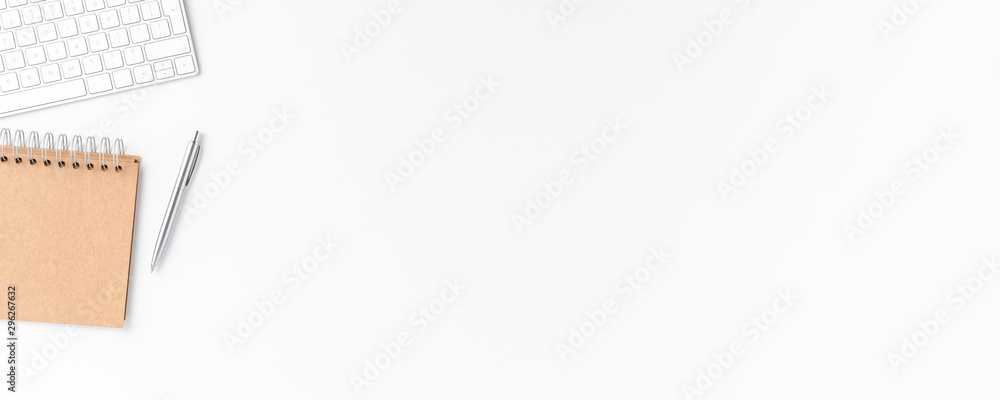 Modern workspace with keyboard, notebook and pen. Office desktop. Top view. Banner Modern workspace with keyboard, notebook and pen. Office desktop. Top view. Banner