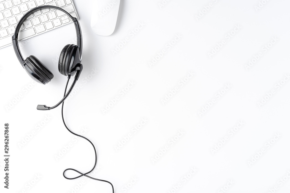 Helpdesk desktop with headset and computer accessories. Call center