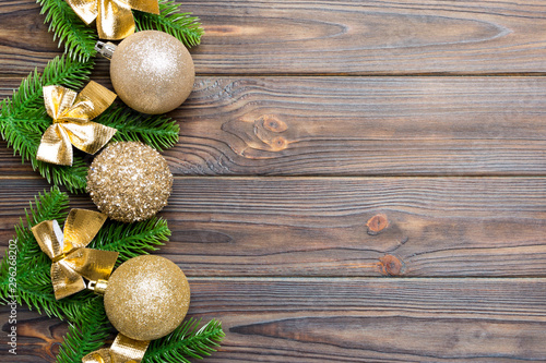 Set of festive balls, fir tree and Christmas decorations on wooden background. Top view of New Year ornament concept with copy space