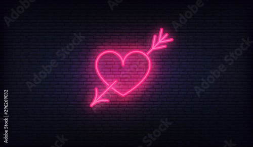 Heart with arrow neon sign. Glowing purple heart signboard design