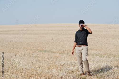 South asian agronomist farmer inspecting wheat field farm. Agriculture production concept. © AS Photo Family