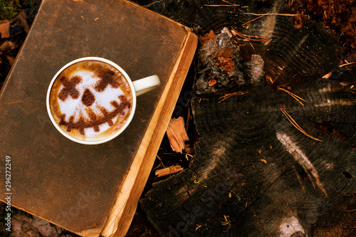 Coffee cup as jack o lantern pumpkin