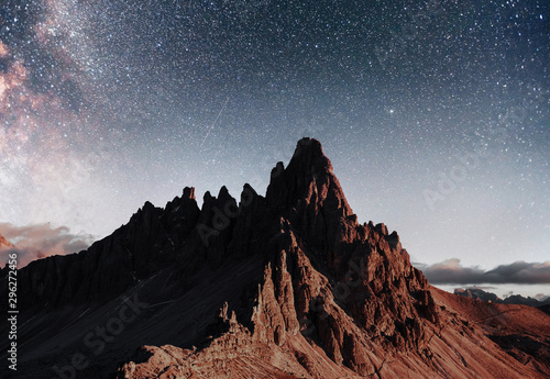 Outstanding background. Photo of the big dolomite mountains with clear night sky with stars