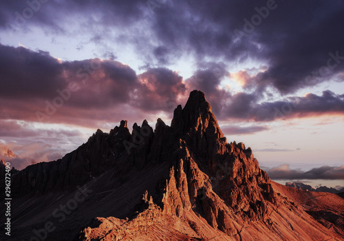 Beautiful landscape. Photo of the big dolomite mountain at sunset time with clouds above