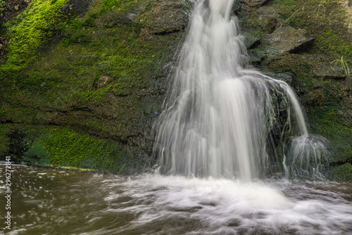 Fototapeta Naklejka Na Ścianę i Meble -  waterfall over mossy rocks