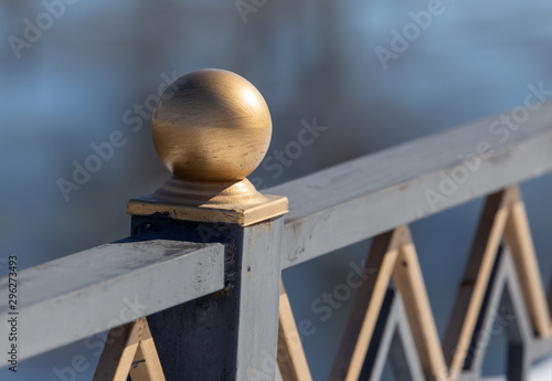 Golden ball on a metal fence