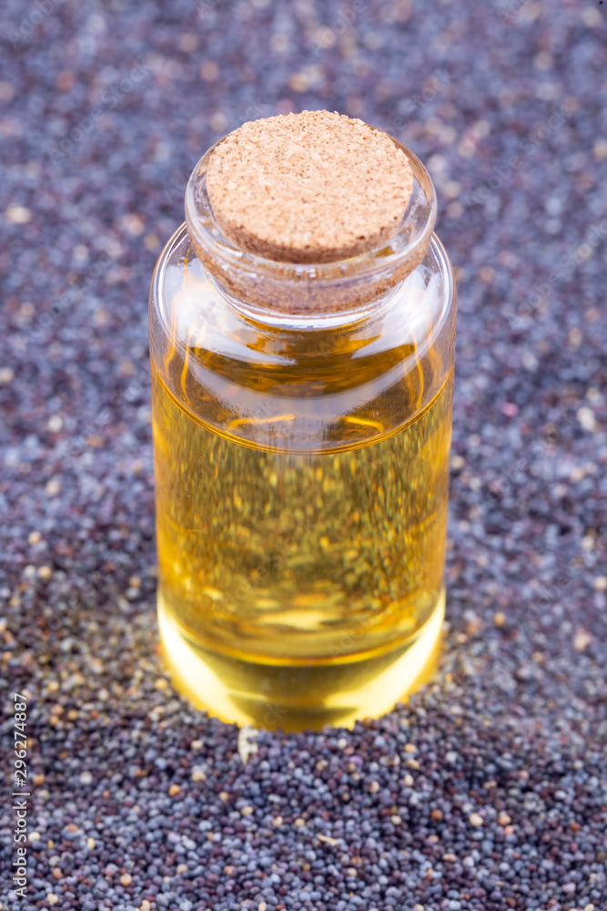 Poppy seeds with essential oil in a small jar Poppy seeds with essential oil in a small jar