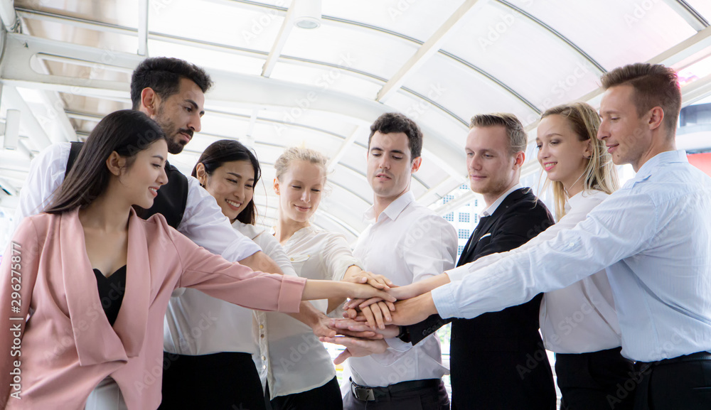 Low Angle View Of Business Coworkers Doing Fist Bump While Standing Outdoors Low Angle View Of Business Coworkers Doing Fist Bump While Standing Outdoors