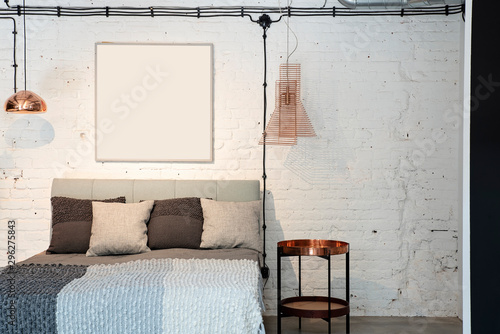 Fotografie Modern interior of bedroom with stylish furniture, bed, table and gold lamp