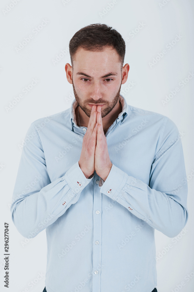 Vertical photo. Man in official clothes stands against white background in the studio Vertical photo. Man in official clothes stands against white background in the studio