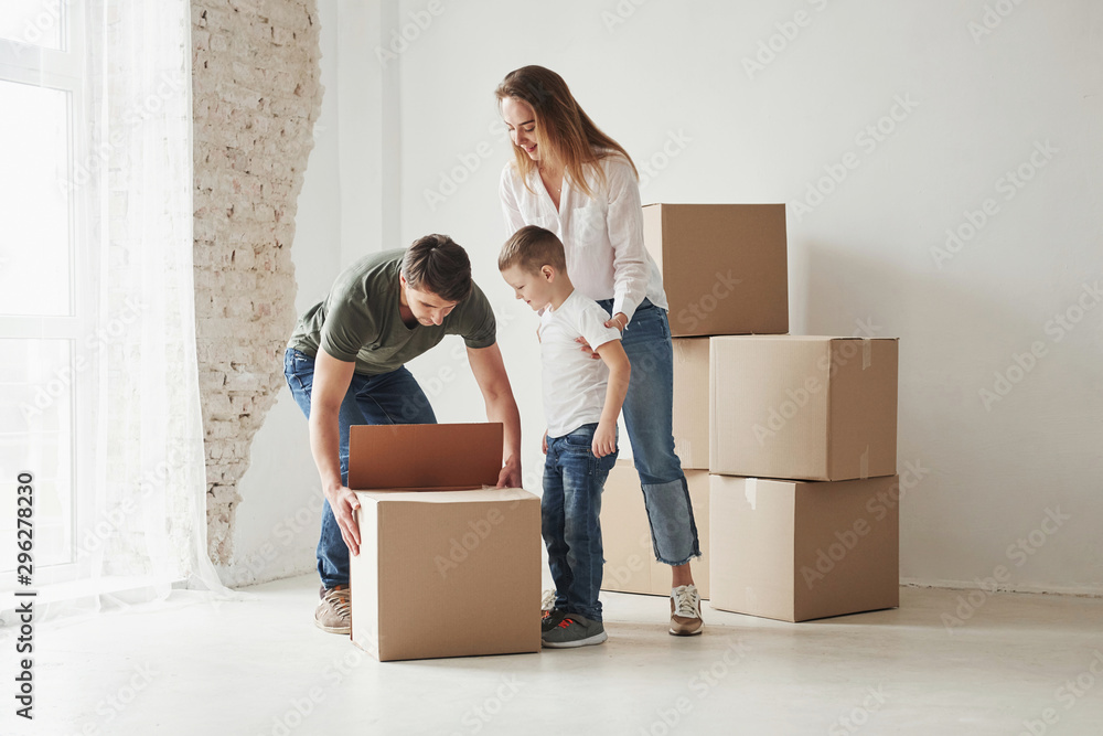 Let's take this out. Family have removal into new house. Unpacking moving boxes Let's take this out. Family have removal into new house. Unpacking moving boxes