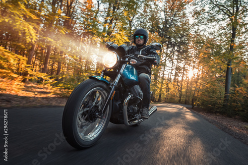 Motorcycle driver riding in foreste landscape