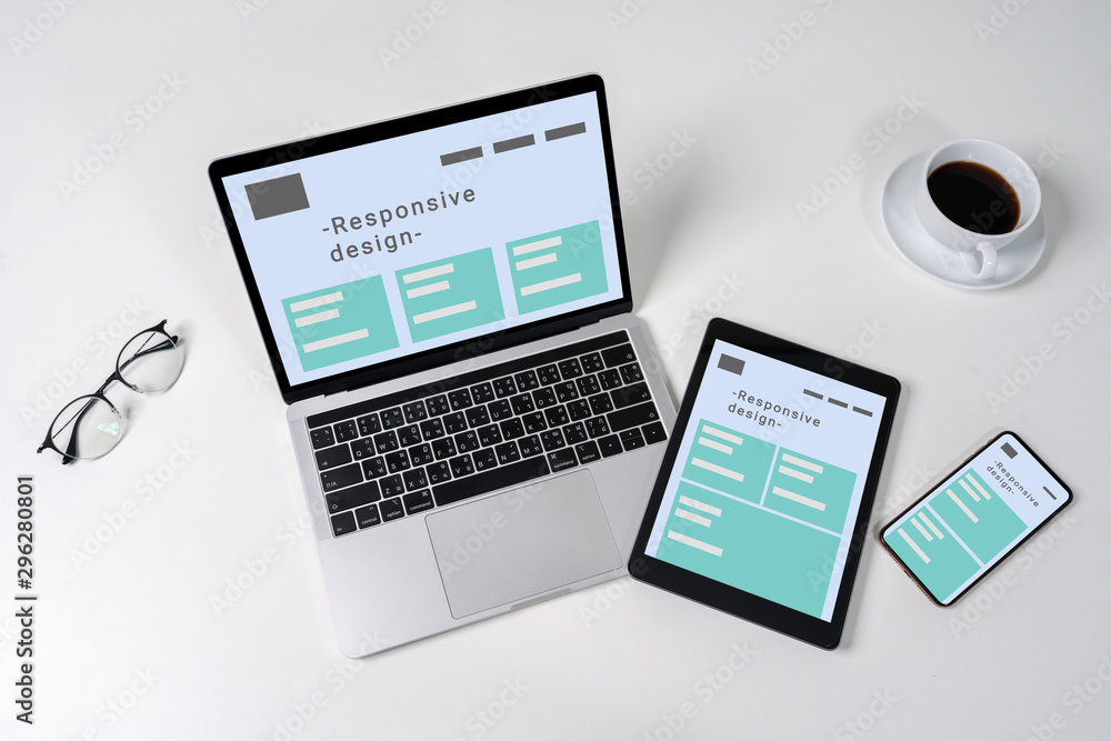 Responsive web design on laptop, tablet computer and mobile phone with clipping path from above. Responsive web design on laptop, tablet computer and mobile phone with clipping path from above.