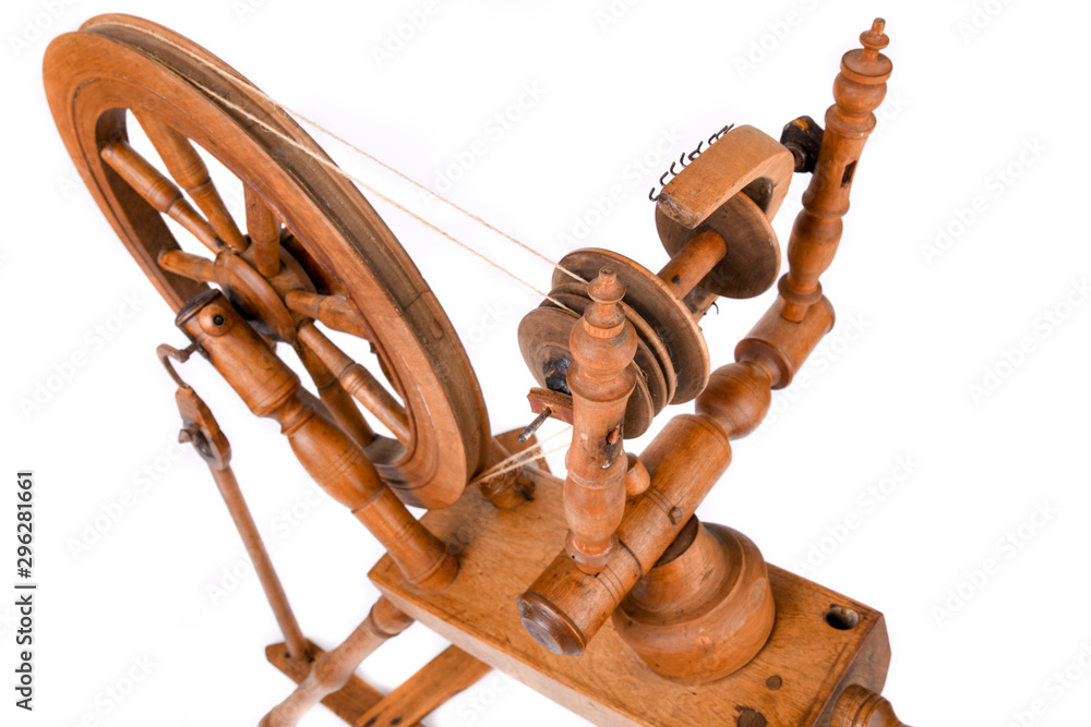 Closeup of old spinning wheel isolated on a white background. Very old