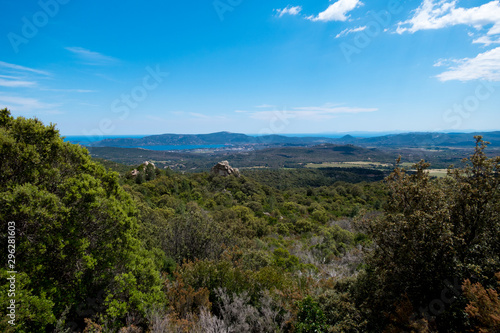 Landscape shot with green forests, mountains and a blue sky