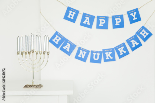 Menorah near Happy Hanukkah garland photo