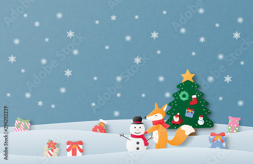 Merry Christmas and Happy new year greeting card in paper cut style. Vector illustration Christmas celebration background with happy baby fox making snowman on snow field. Poster, wallpaper, backdrop.