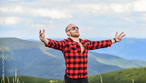 sense of freedom. countryside concept. farmer on rancho. travelling adventure. hipster fashion. man on mountain landscape. camping and hiking. sexy macho man in checkered shirt. cowboy in hat outdoor