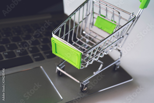 Mini supermarket trolley on the laptop keyboard