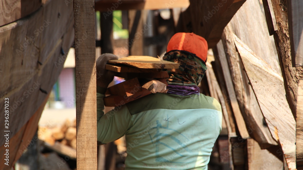 Timber shipbuilder working while working at a shipyard, Batang Indonesia, 14 October 2019