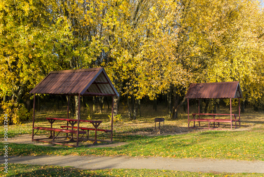Free gazebo bower for relaxing in the autumn public park. Free gazebo bower for relaxing in the autumn public park.