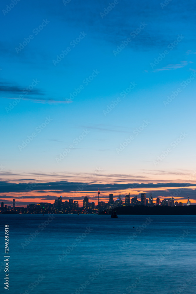 Dusk Sydney skyline with blue sky.