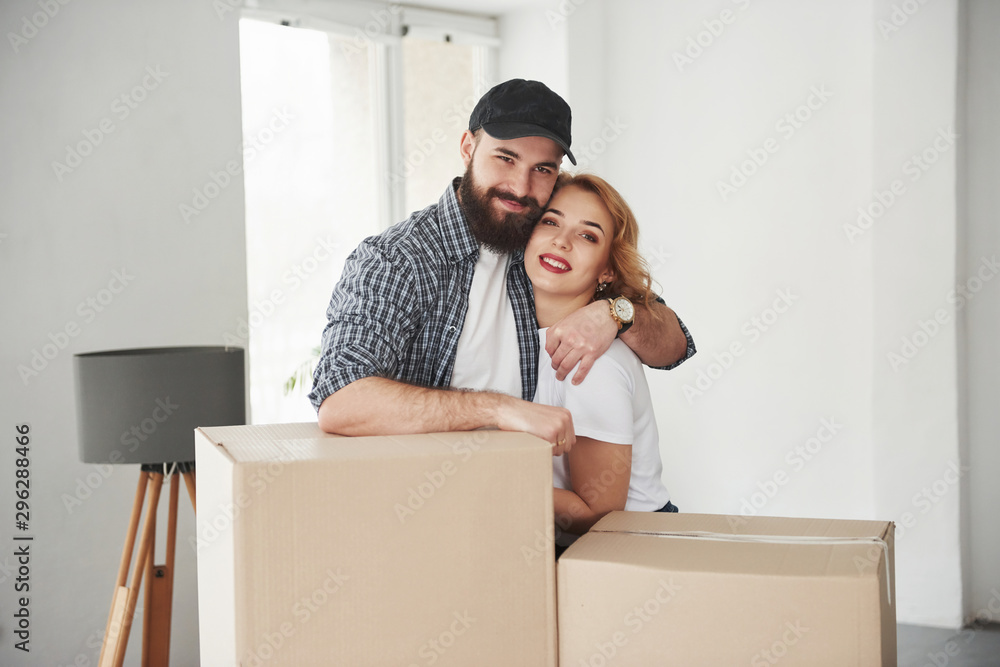 Embracing each other. Happy couple together in their new house. Conception of moving Embracing each other. Happy couple together in their new house. Conception of moving