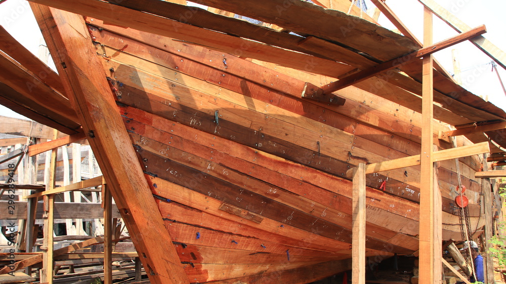 Timber shipbuilder working while working at a shipyard, Batang Indonesia, Timber shipbuilder working while working at a shipyard, Batang Indonesia,