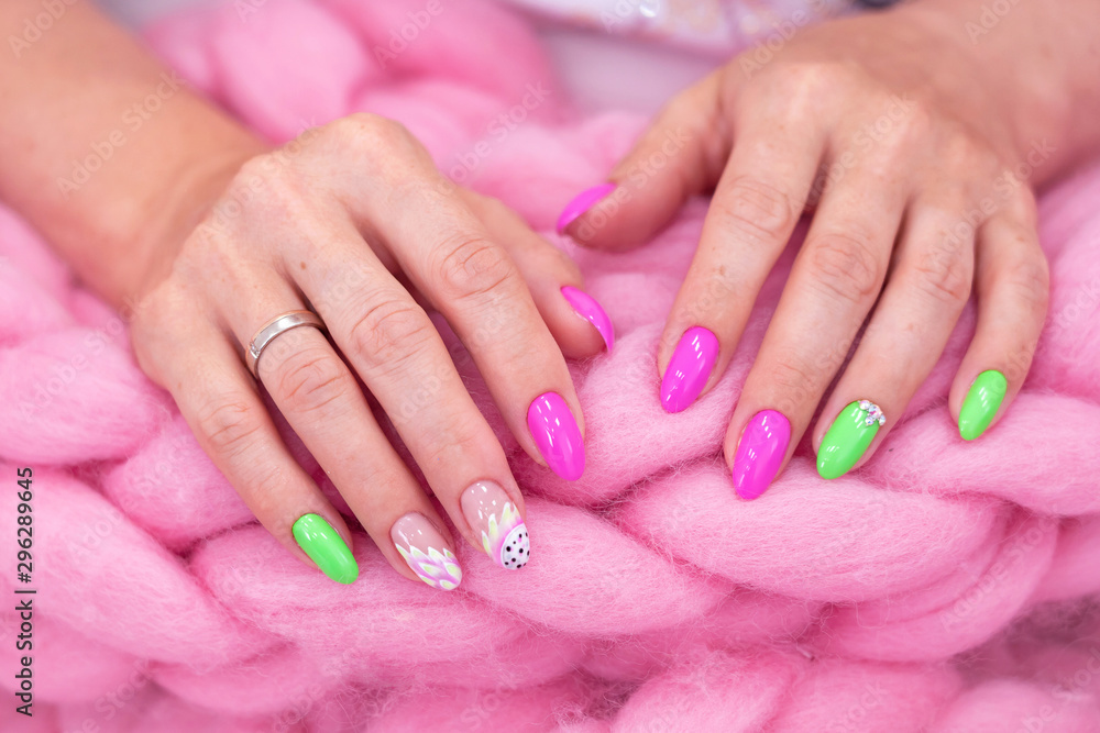 lots of color gloss manicure hands has different blotches in pink background
