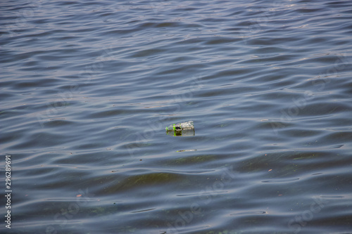 Green water in the Dnieper. Trash floating in the river. Background like texture..