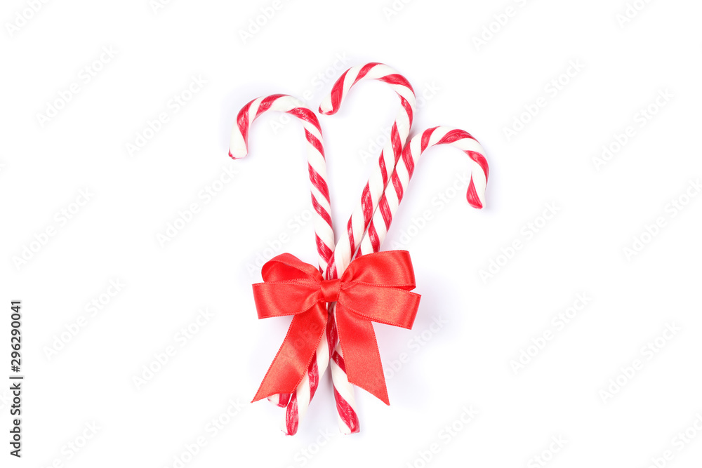 Sweet candy canes with bow isolated on white background Sweet candy canes with bow isolated on white background
