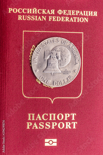 Russian passport and coin in one dollar on it. The passport of the traitor.